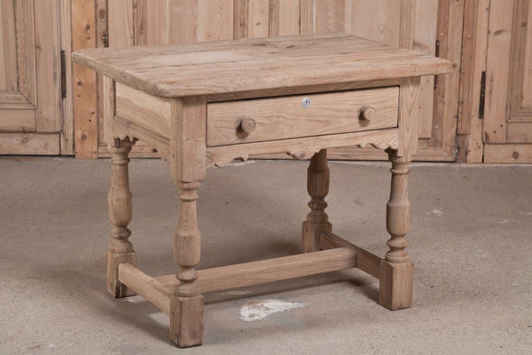 Benchmade from solid European white weathered oak to last for generations, this simple yet appealing French table features a convenient drawer with turned legs and an 