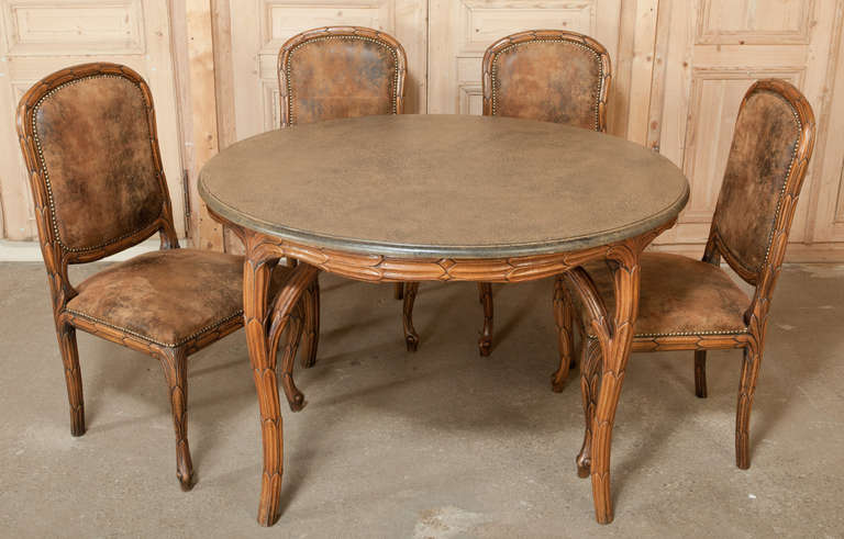 The perfect breakfast set, or more enjoyably as a game table set, this Art Nouveau Round Table and 4 Chairs were beautifully sculpted from select French walnut with a foliate motif adorning the entire structures of each piece.  A faux finish on the