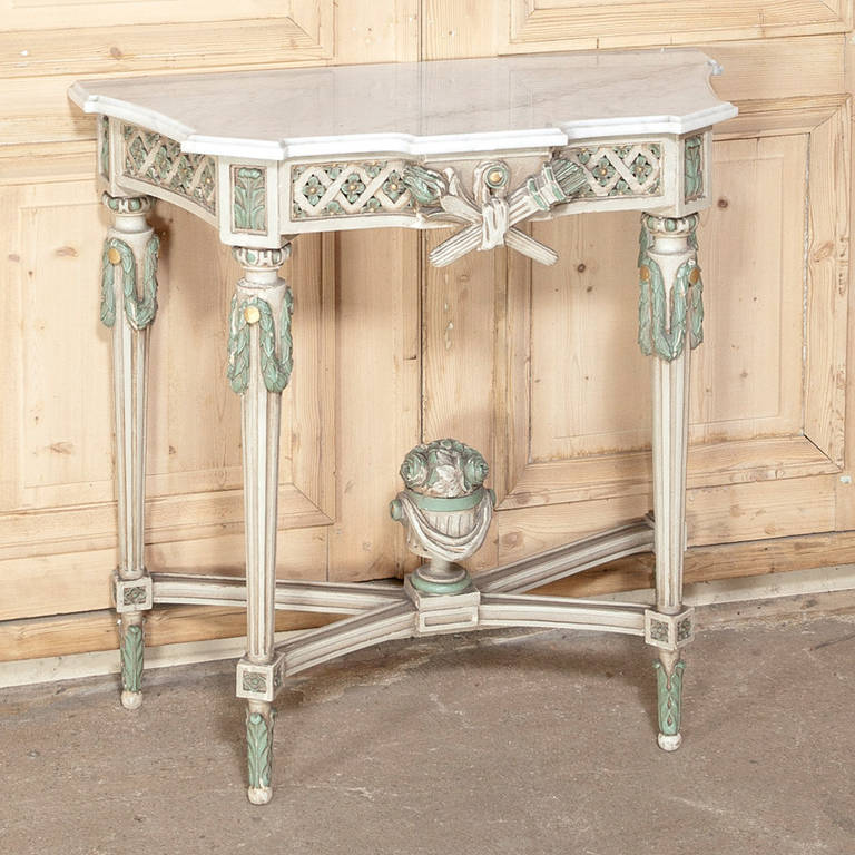 Not only did the master artisans create antique furniture as a beautiful sculpture from the amazing crown to the urn on the stretchers below, this stunning Antique Louis XVI Polycrome Painted Mirror with Marble Top Console was made to bedazzle even