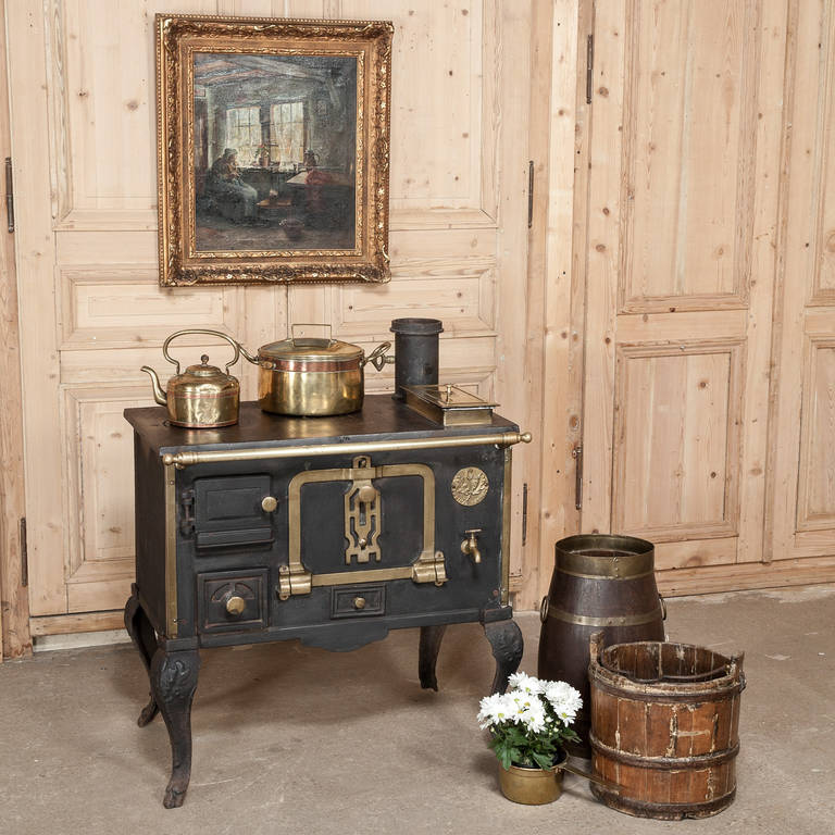 This gorgeous example of the culinary antique was carefully restored and is truly a labor of love that some patient soul performed many years ago for our amusement and enjoyment. Cast from solid Iron then fitted with brass rails, knobs and trim,