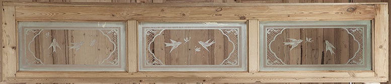 Hand-crafted from solid yellow pine, this triad of doors feature their original etched glass panes with classical scenes, plus they survive with their original matching transom, also with etched glass! Perfect for defining an interior space or