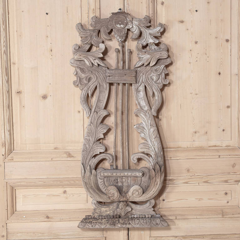 This Antique Architectural Remnant makes for a delightful accent piece!  Hand-carved over a century and a half ago, it depicts a lyre rendered in rich acanthus flourishes.
Measures 43H x 20W
Circa 1850s