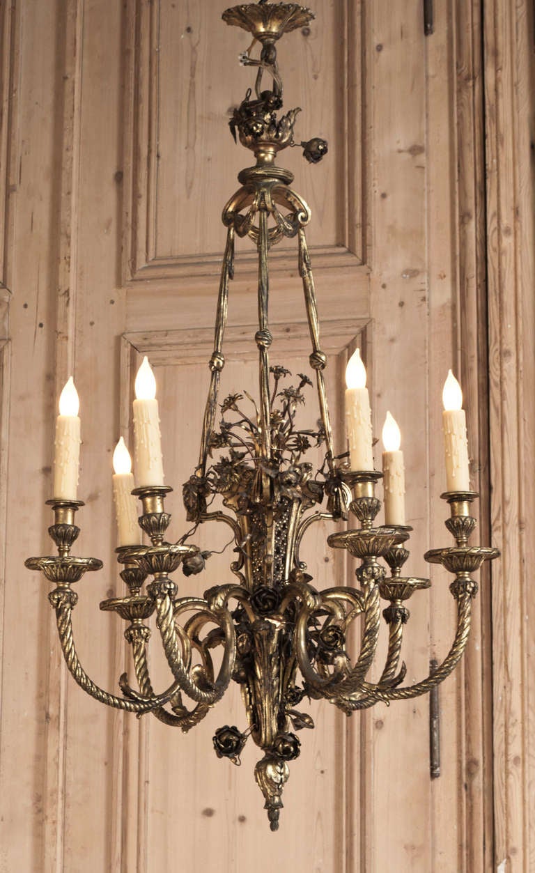 19th century antique French Louis XVI gilded brass Parisian chandelier was cast to an incredible degree of detail in the neoclassical style from solid bronze and brass. With a romantic corona decorated a cast bouquet of flowers appearing above three