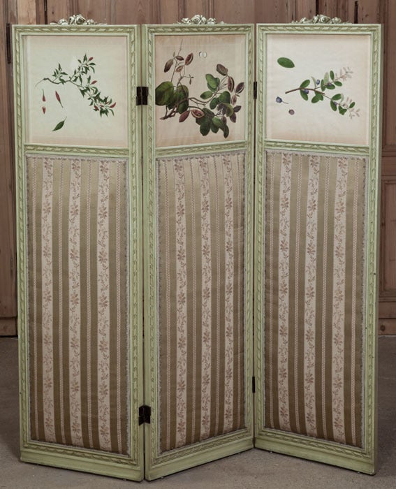 Perfect for creating a partition or an accent, this Neoclassical Louis XVI 19th century three-panel dressing screen boasts its original painted finish with gold highlights, accentuating the subtle floral and foliate carvings that permeate the
