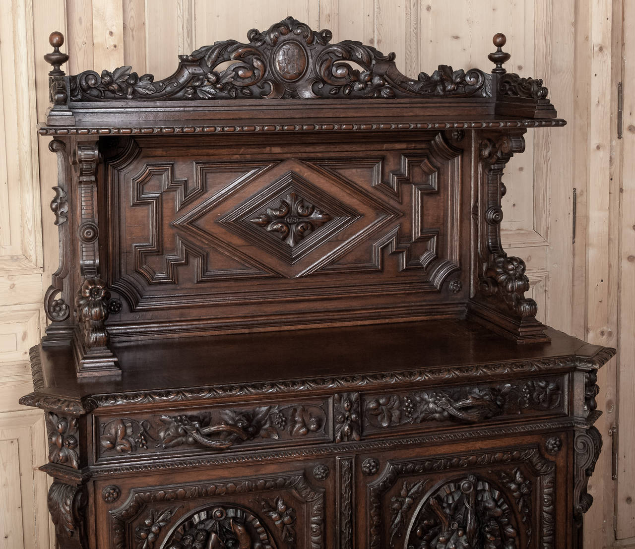 This Antique Hunt Vaisselier was carved by master French craftsmen in the region around Rouen, and features game from the hunt in glorious full relief on each door panel, complemented by bounty of the earth motifs in abundance on the crown and