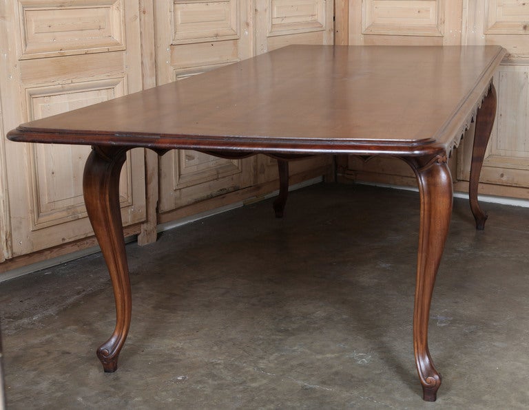 Hand-crafted from solid fruitwood in an elegant yet simple expression of Country French style, this table stretches nine feet in length to serve your guests with aplomb! Graceful cabriole legs with undulating apron provide visual appeal, while the
