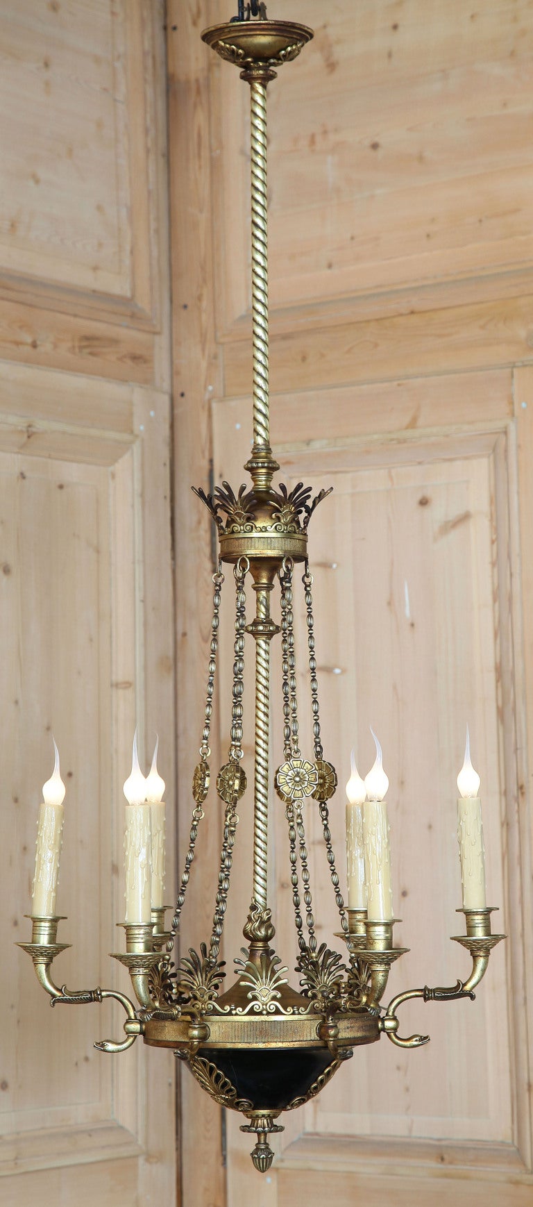 Hand-crafted from solid brass and bronze, this stunning chandelier is a definitive example of First Empire style and Second Empire quality! The brass bell at the bottom has been finished in a very dark green as was the custom, which contrasted with
