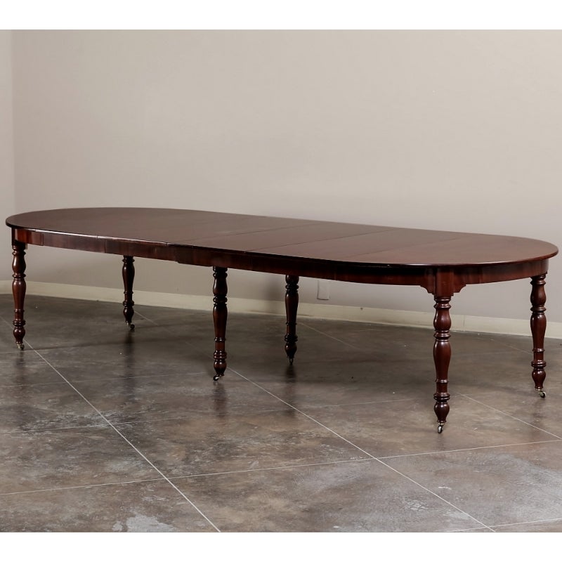 Grand in scale to seat 12 to 14 guests this gracefully carved from exotic imported mahogany in a Classic characteristic of Louis Philippe period pedestal table is an instant family heirloom. Such antique French banquet table is perfect for