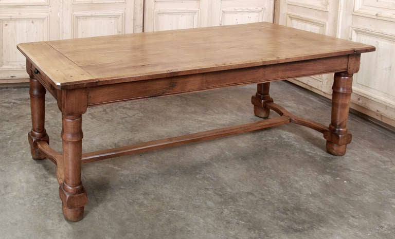 We found this charming 19th century Country French Farm Table on one of our buying trips to France. Hand-crafted from solid planks of blonde French walnut in the early days of 19th century, this age old beautiful rustic patina of antique farm table