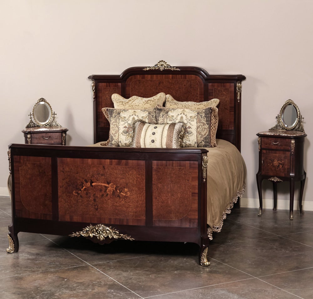 Combining burl walnut panels with exotic rosewood inlay to create artistic expressions, known as marquetry, this antique French Louis XV bed features extended original rails so it will accommodate a standard Queen size mattress! Beautifully cast
