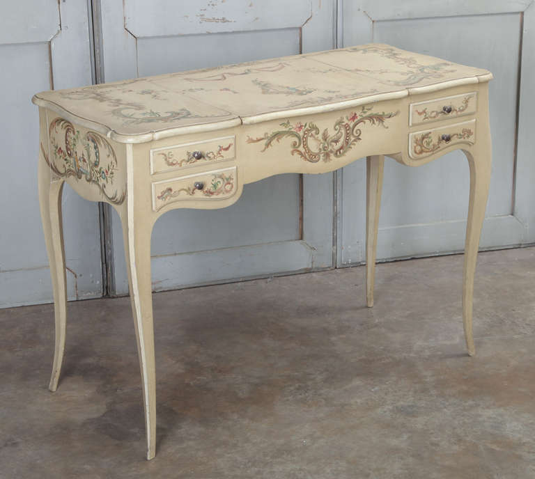 Painted detail across the entire facade, including the top, this Vintage French Louis XV Painted Vanity will add color, flair and functionality to your drawing room or bedroom!  Top flips open to reveal mirror for makeup and jewelry, with convenient