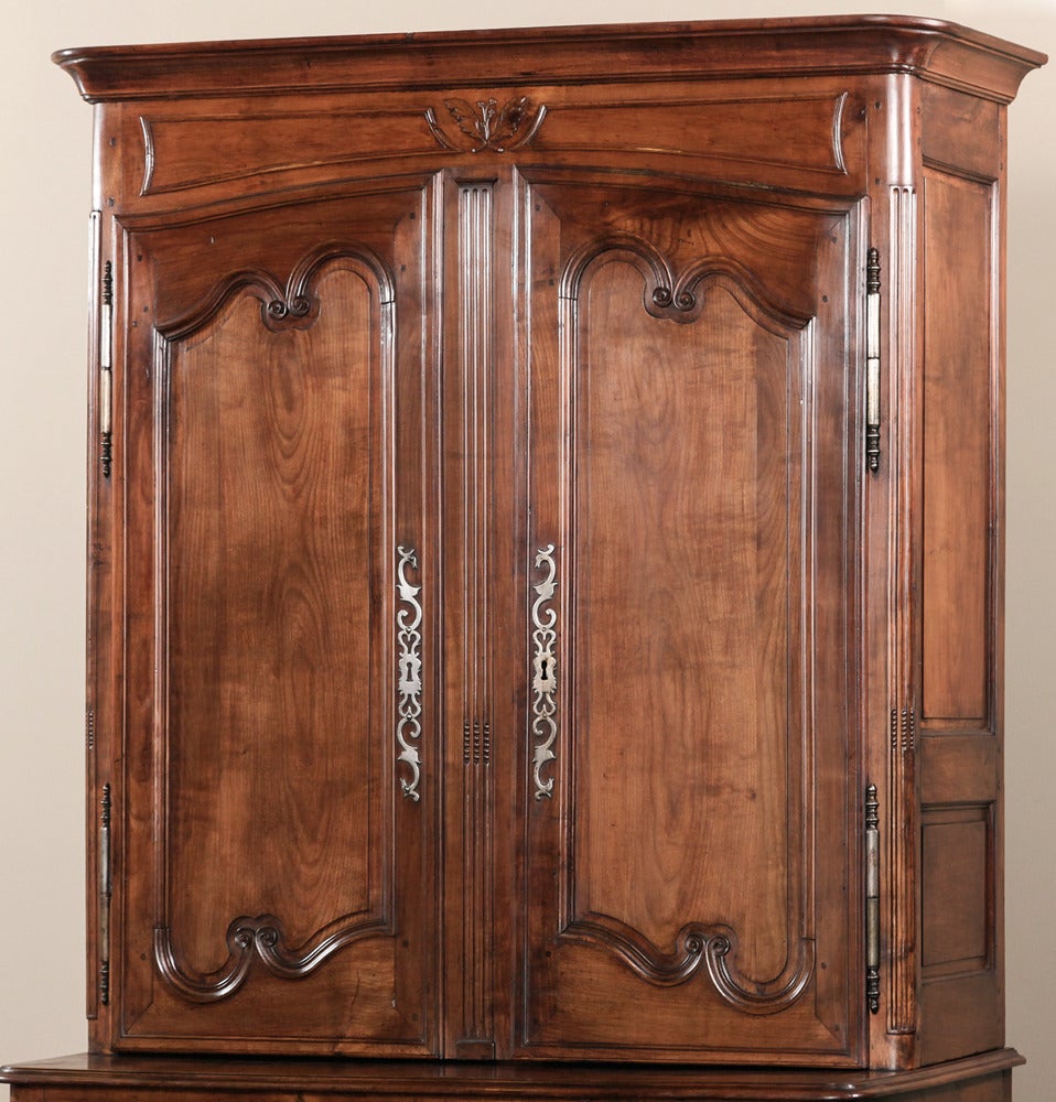 Handcrafted from solid blonde French walnut, this imposing 18th century Provençal buffet a deux corps would have been the focal point of any room in which it was placed! Classic French scrollwork combines with a modicum of carved embellishment and