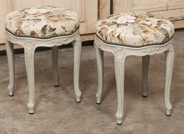 Sculpted in the Rococo manner, this Pair of vintage French Louis XV painted stools feature recent floral upholstery and the patinated painted finish highlights the foliate, shell and floral carvings perfectly!
Circa early 1900s.
Each measures 18H