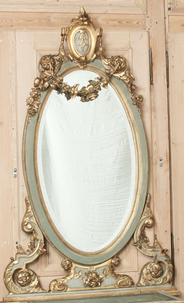 Produced only as master Italian artisans can produce, this stunning hall piece is actually two parts: a display cabinet below and a mirror above, and what a combination they make! The beveled oval mirror is a study in Baroque opulence, with a cameo