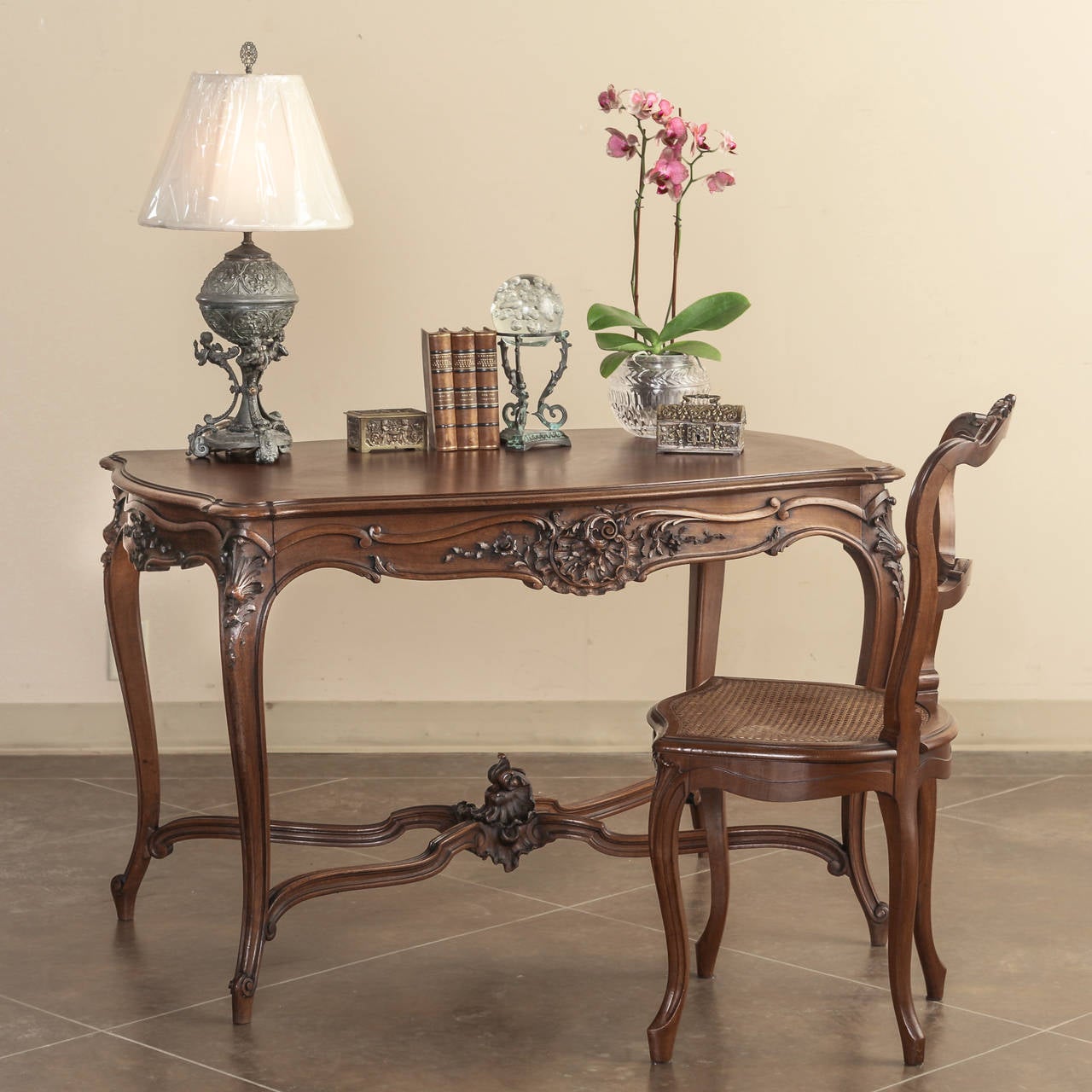 Sculpted from select French walnut, this antique French Louis XV walnut writing table makes the perfect 21st century desk! Graceful cabriole legs joined with double lyre stretchers provide stylish support, while the large drawer provides ample