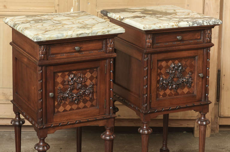 The tailored architecture and classical styling favored by Louis XVI have been rendered here in exotic imported mahogany and fine Carrara marble. Tapered and fluted legs connected with a lower shelf support the cabinet and drawer for each, which are