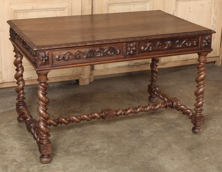 Sculpted from select French walnut in the timeless Renaissance manner, this Antique French Writing Table is perfect for the 21st Century office or library!  Foliate relief covers the apron all around, including the drawers, framed by demilune