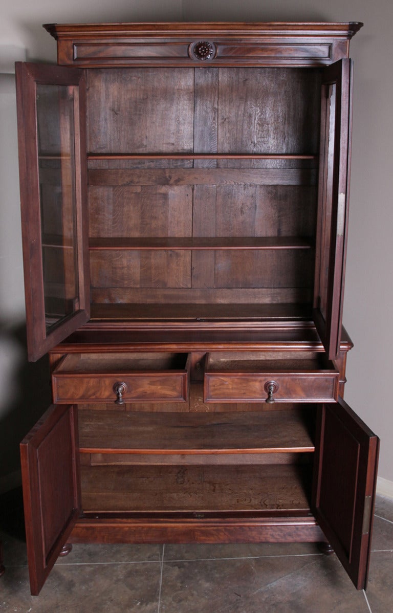 Pair 19th century French Louis Philippe bookcases was fashioned from solid mahogany, and provides both display storage on top, and concealed storage below. The tailored architecture of this style has always been a favorite of designers and savvy