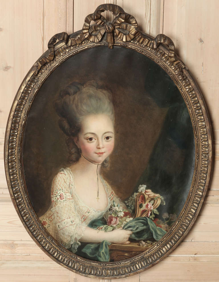 Portraying an elegant and affluent young maiden, this Antique 18th Century Framed Oil Portrait has survived the centuries with its original frame.  The maiden's captivating smile and bouffant hair style were popular during the Louis XVI period, and