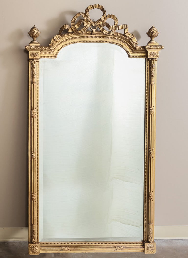 Perfect for adding elegant neoclassical style and flair to any room, this 19th century French Louis XVI gilded mirror harkens back to a golden age in French design, when Classic styles were reborn for us to appreciate for centuries to come! This
