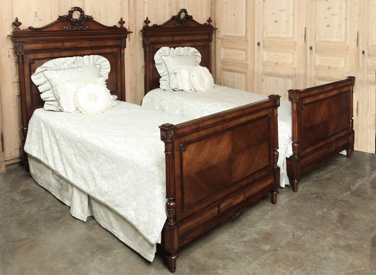 This exquisitely preserved Pair of Antique French Louis XVI Beds were hand-crafted from select French walnut by master artisans in Paris!  The detail is simply remarkable, from the headboard crown to the subtle adornment on the footboards. 
Circa