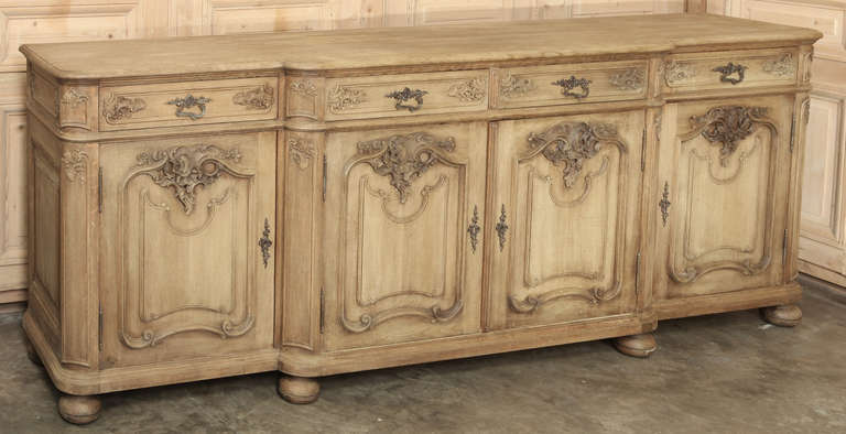Vintage Country French Step Front Buffet boasts copious storage with hand-carved style! 
Circa early 1900s. 
Measures 37.5H x 98W x 21D.