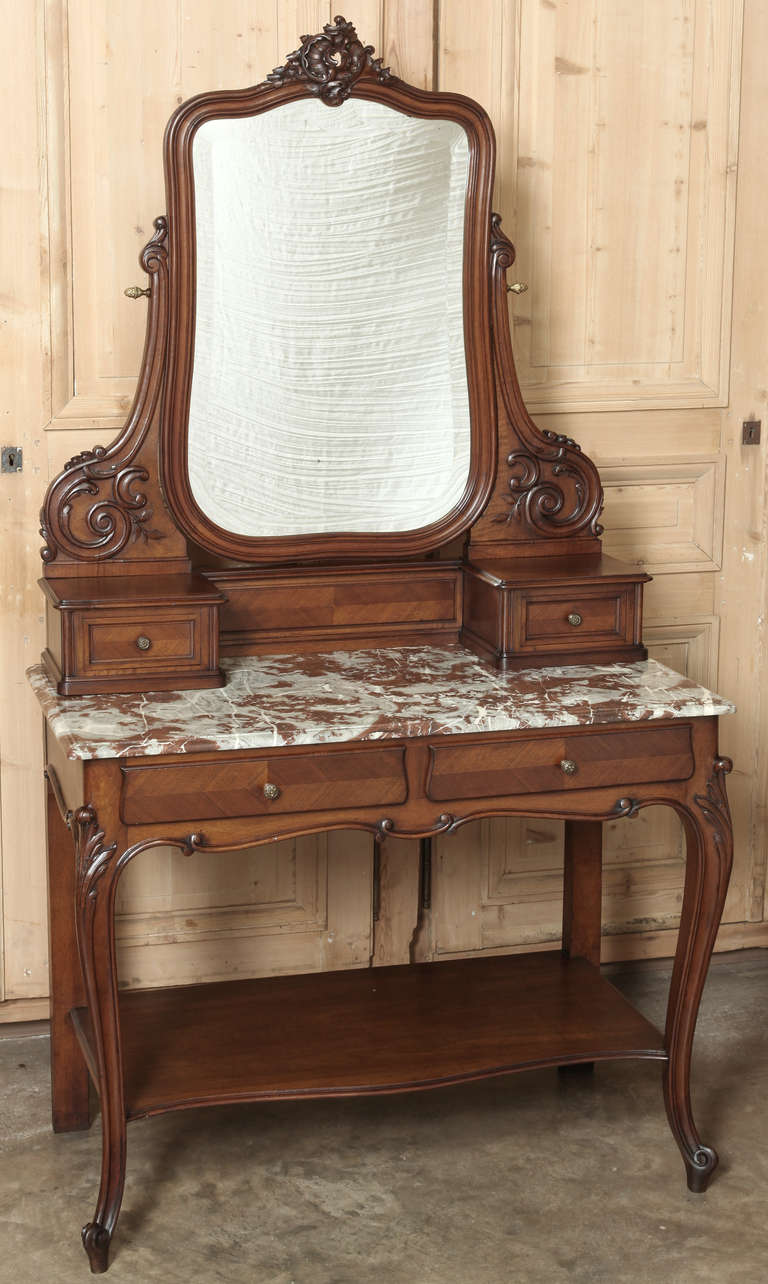 Antique French Louis XV Walnut Vanity boasts original beveled mirror and sumptuous carefree marble top! 
Circa 1890s. 
Measures 72 x 39.5 x 20; surface 31.5.