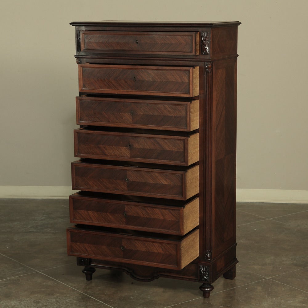 Designed with a drawer for every day in the week, this antique French Louis XVI rosewood semanier is a chest that can hold an abundance of clothing! Crossmatched veneer panels dominate the facade, accented with acanthus rosettes and fine molded