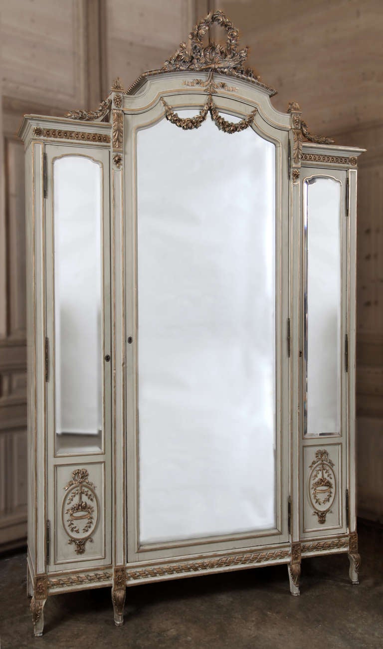 This amazing work will instantly transform any room into a showcase! Soaring nearly 9 feet tall, it is a superlative expression of the classic movement that so enamored Louis XVI and his queen Marie Antoinette. Featuring three large mirrors, the