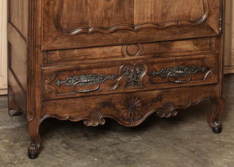 Boasting incredible visual appeal, this handsome bonnetiere was crafted from solid fruitwood, and features an amazingly intricate ferrure, or keyguard along with matching drawer pull guards and keyguard below on the full width drawer. Stunning