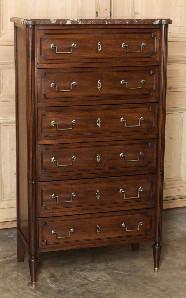 The formal chiffoniere, modeled after the semainier is a more sensible solution to keeping one's fine clothing organized. This example, with tailored architecture that calls attention to the sheer beauty of the fine imported mahogany, provides six