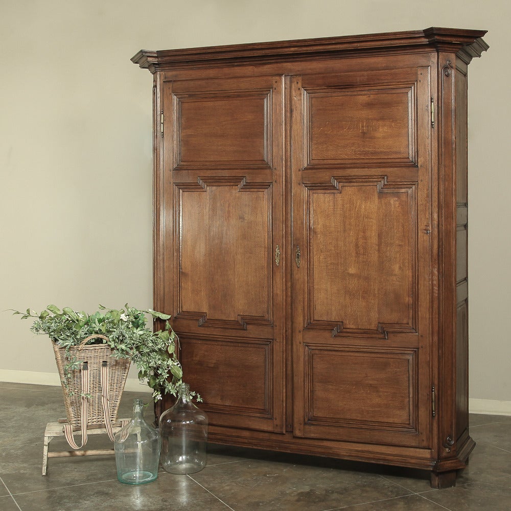 Antique Country French armoire crafted in 19th century by talented European artisans. Truly a phenomenal creation of a timeless work of art from a bygone era, this antique Louis XVI armoire was rendered in solid oak to last for centuries! 
circa