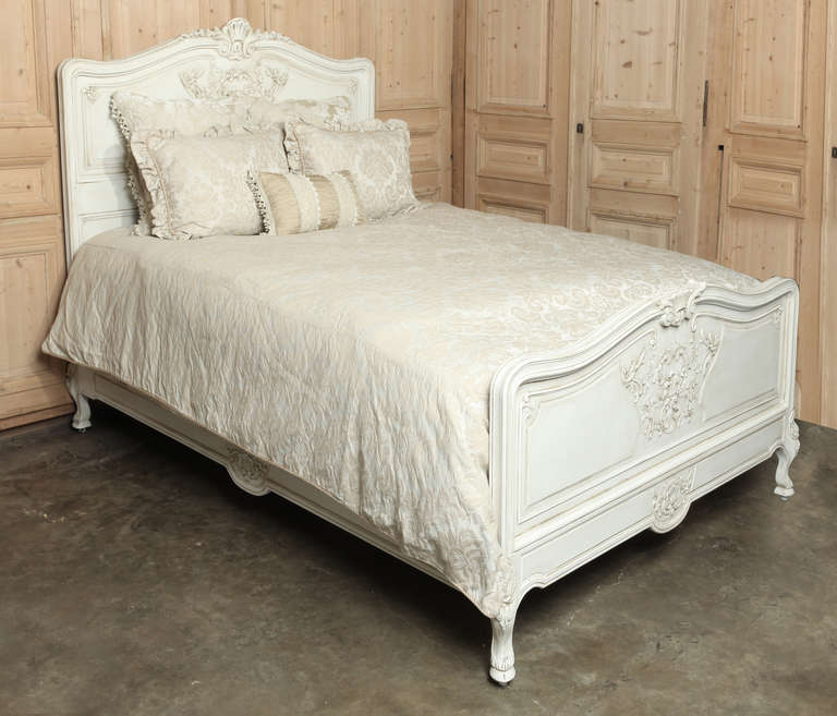 Sculpted from solid oak with classic styling, then given a patinaed painted finish, this Vintage French Regence Painted Queen Bed accepts a queen size mattress set! Circa early 1900s. Headboard measures 61H x 62W; footboard is 32.5H x 62W; rails