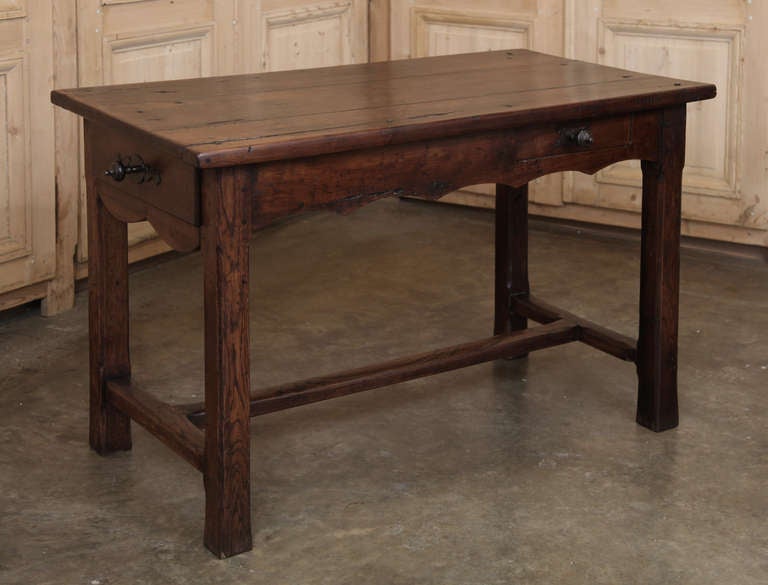 Hand-hewn from the stately sycamore tree, this farm table was produced by rural artisans who used a no-nonsense approach to build a functional table that would last for generations. Featuring a drawer on the short and long sides, both with turned