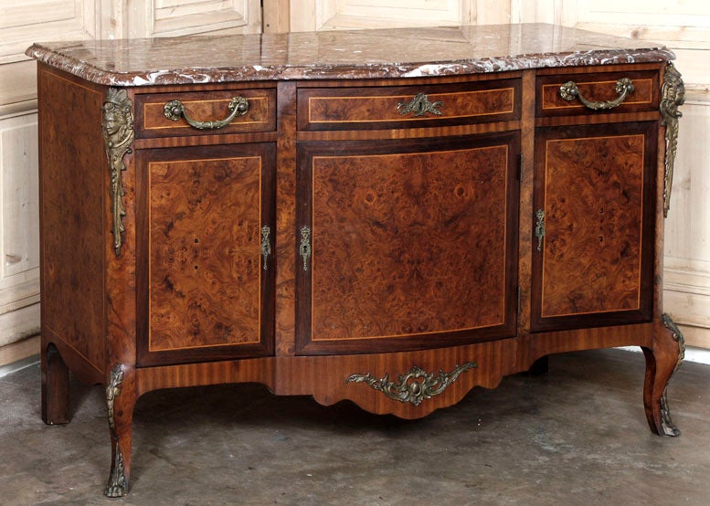 This superb buffet combines the expert ministrations of the ebeniste as well as a stone mason, and of course a metalsmith, all of whom worked together to create an instant family heirloom! With exquisite burl walnut veneering on the panels which are