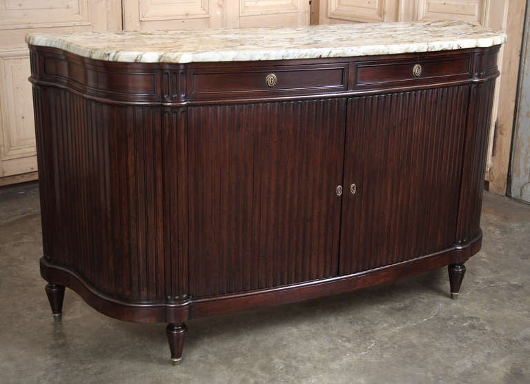 The firm of Krieger is well known to aficionados of 19th century Parisian furniture buffs, and this example is a clear reason why. Exotic imported mahogany, available only to the finest furniture houses, we employed in an unusual tambour effect