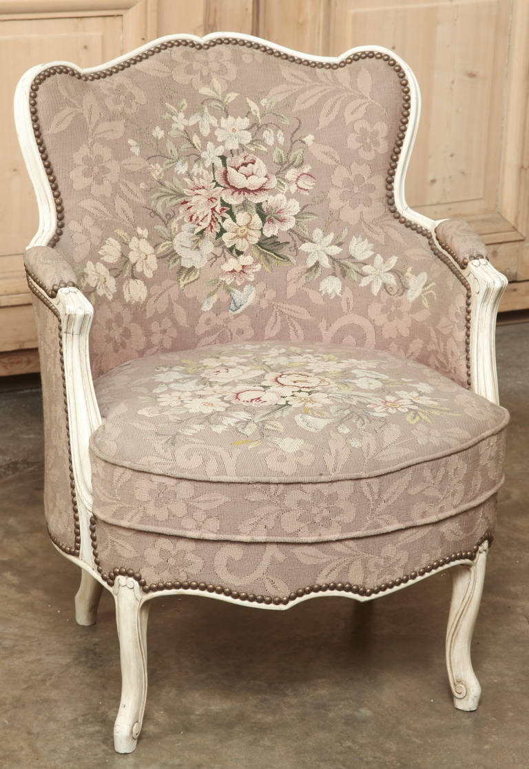It's difficult to know whether the upholstery or the framework required more work, but works like this superb antique Louis XV painted needlepoint bergère are definitely examples of superior hand-craftsmanship! The undulating frame bears a painted