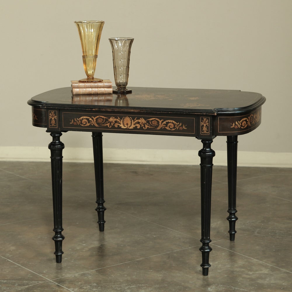 Featuring an ebonized walnut backdrop providing a canvas for the intricate marquetry detail, this incredible Louis XVI end table was obviously crafted by true artisans! Multiple species of wood were used in the marquetry to portray a floral bouquet