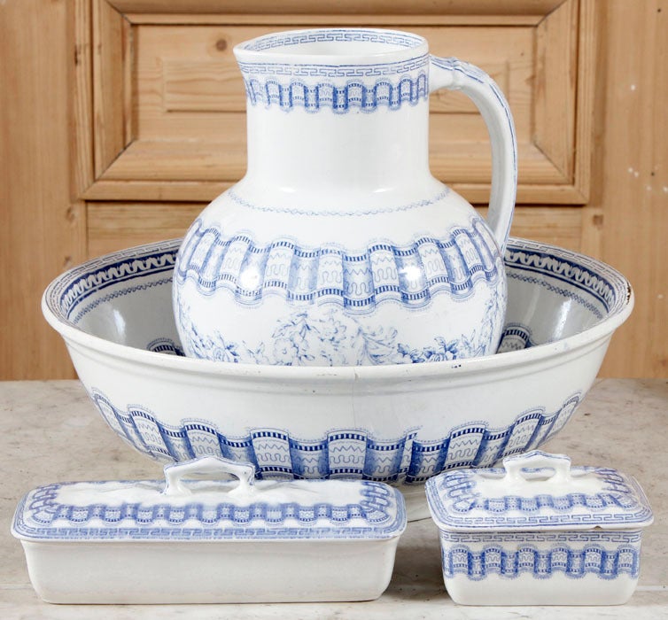 Consisting of a pitcher, bowl, toothbrush holder and covered soap dish, this washstand set was just the ticket for getting cleaned up in the morning. Blue transferware pattern adds color and flair.