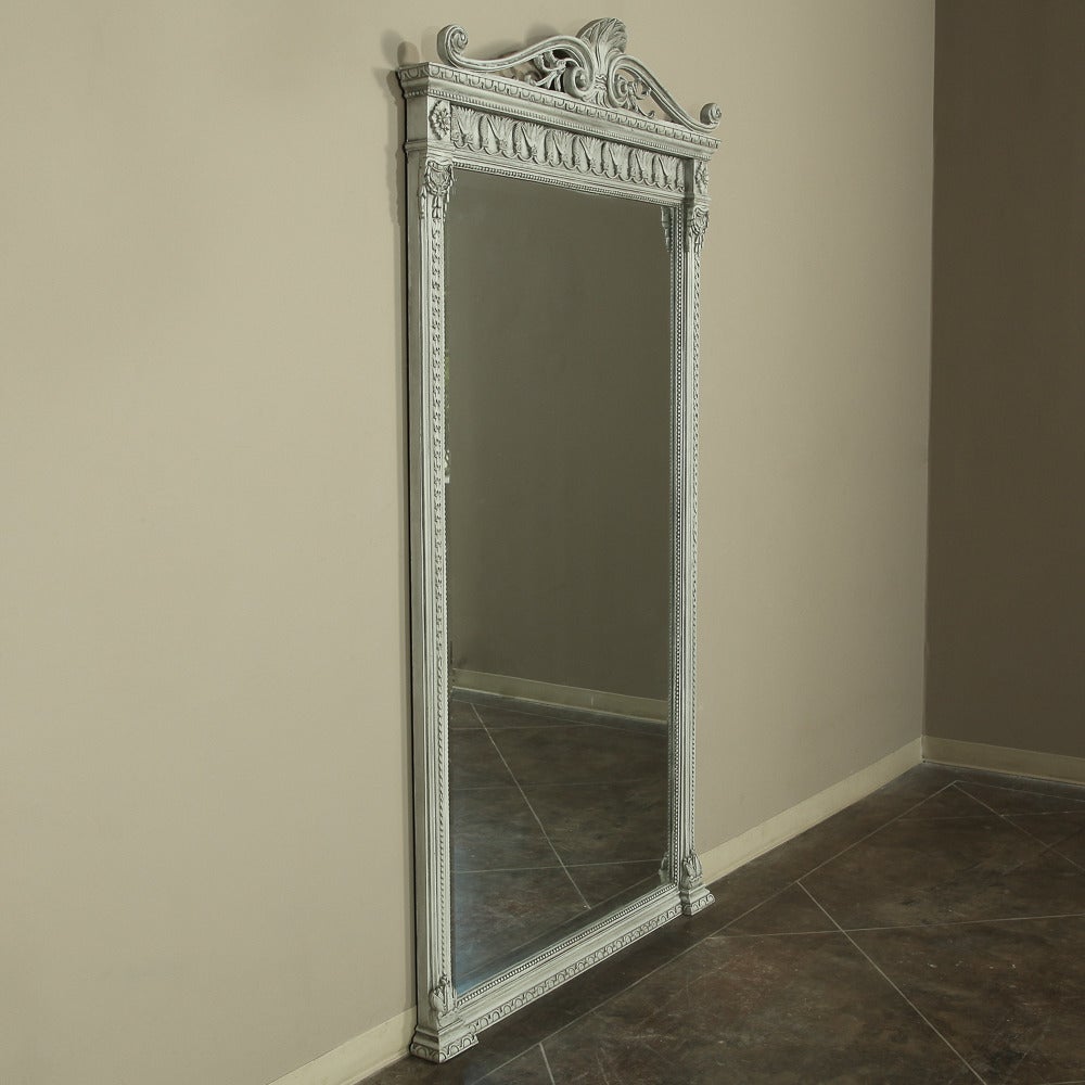The superb timeless styling of this French neoclassical painted mirror ensures that it will immediately become the focal point of any room! From the shell atop the arbalette crown to the intricate detailing of the frame all around it is sure to