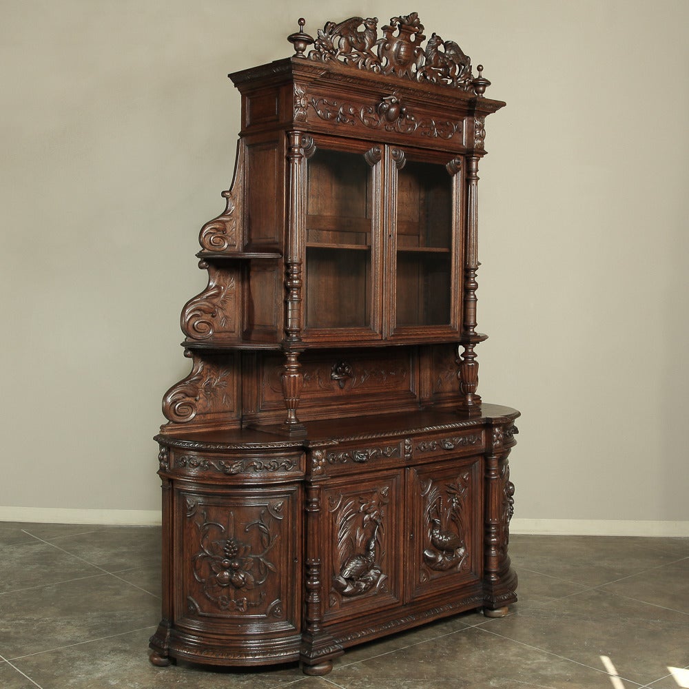 Handcrafted on a grand scale from solid old-growth oak, this magnificent mid-19th century French Renaissance hunt buffet will be an excellent choice as a bookcase or display case as well! Soaring over nine feet tall, it features scenes depicting the