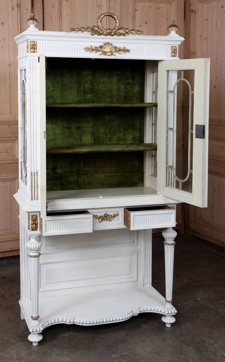 This unusual piece features a variety of attributes not normally found in one artifact. First, it has been designed along the classic architecture that so enamored Louis XVI. Second, it has been fitted with trim overlay on the glazing on all three