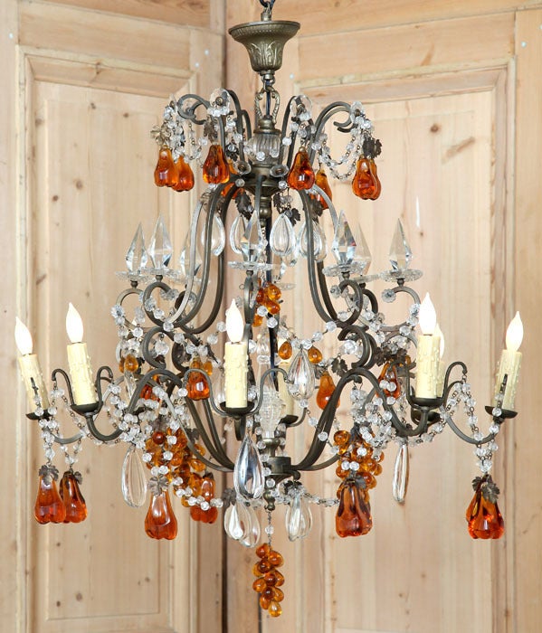 This intriguing chandelier not only exudes Venetian magnificence, it has been adorned with amber colored pear and grape cluster crystals to create a unique effect! Multiple variations of faceted crystals play with the light around your room and