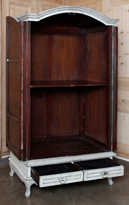 Simply crafted but with fine lines including a boldly arched crown, this rustic armoire features a painted finish with linear highlighting that will make it a perfect choice for that 