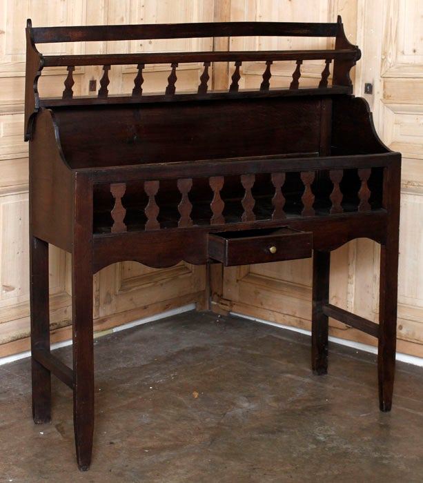 Charming 18th century relic, crafted exclusively from dense, old-growth French white oak, this18th century Country French egoutoir was found in well-established Provencal kitchens, its purpose being to store just-washed pots and pans while drying