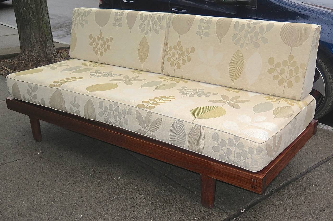 Solid walnut frames, legs. Birch plywood platform. Gorgeous corner details. Has mattress or cushion top and two back pillows for each bed. Some minor corner bumps and scuffs. Fabric has some wear, but very useable as is. Could easily be