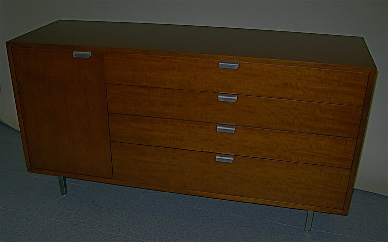 light brown wood (tawny walnut) large J pulls, square metal leg, 2 adjustable shelves. Herman Miller