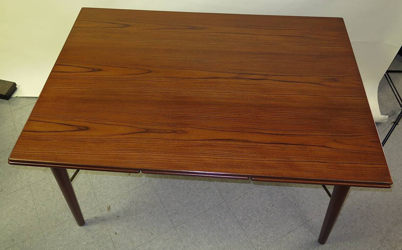 Restored. New lacquer. Beautiful teak grain. Has a couple small indents on top. Has two 19.5 inch leaves. When fully extended, measures 94 inches total. Label for Soborg Furniture-Borge Mogensen designer. John Stuart distributor.