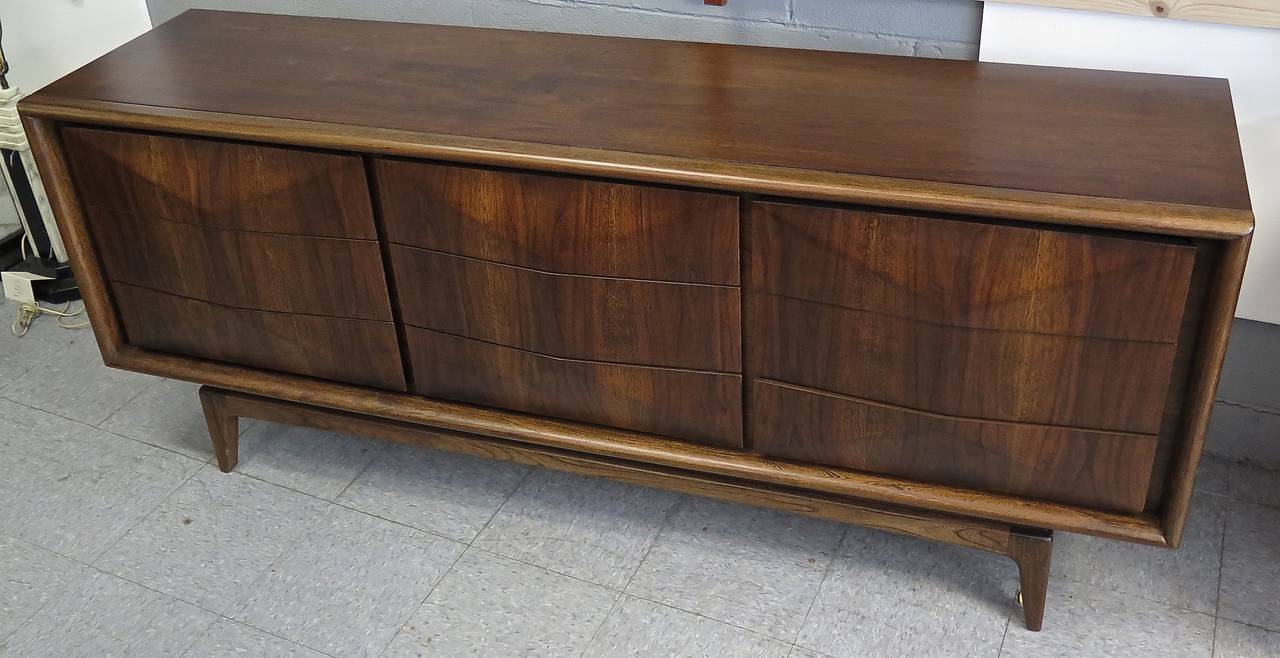 Restored. Constructed mainly of walnut, but also other various wood types. Signed United, possibly the retailer? Few minor scuffs. Great color and design.