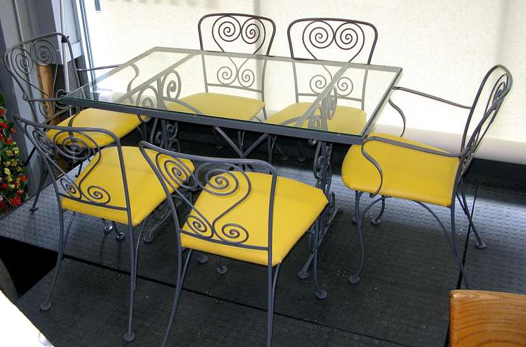 New grey paint. Includes 2 arm chairs and 4 side chairs. Table has brand new glass top. Decorative scrollwork on table base and chair backs. New vibrant lemon yellow indoor/outdoor leather. Chair measures W: 20